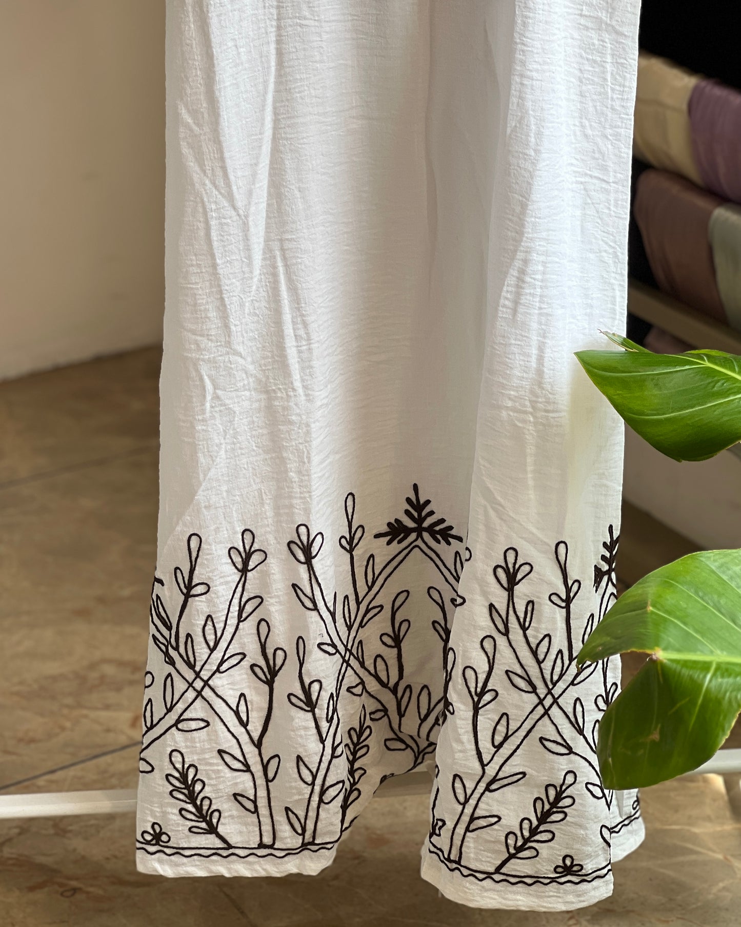 White embroidered pinafore with black inner